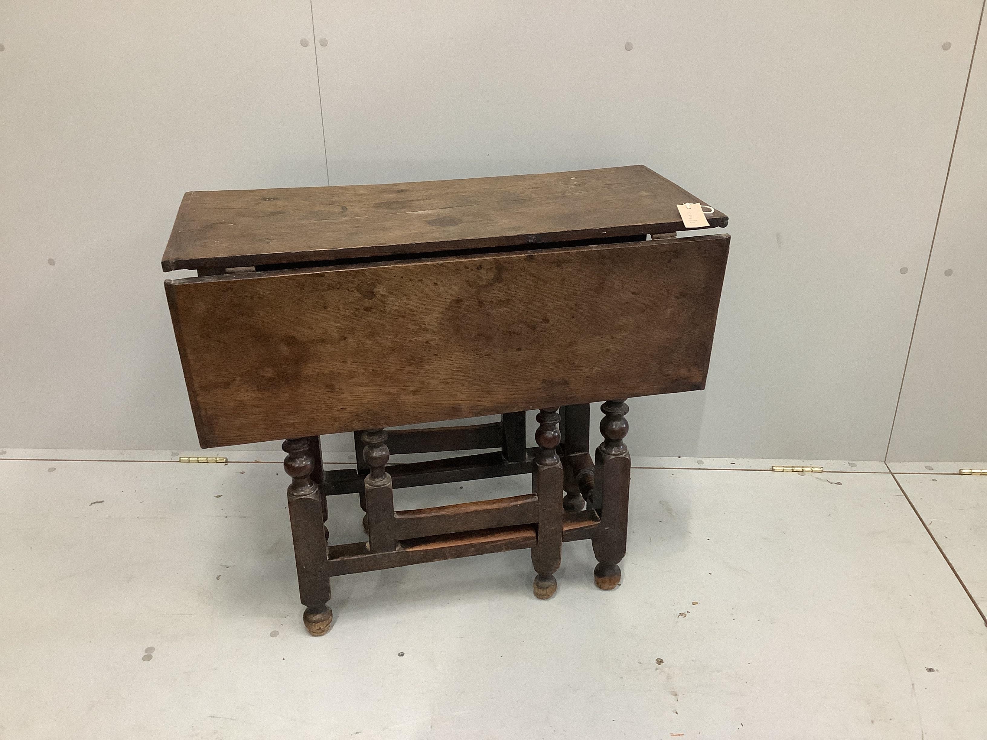 A small 18th century and later oak drop flap table, width 38cm, depth 82cm, height 71cm